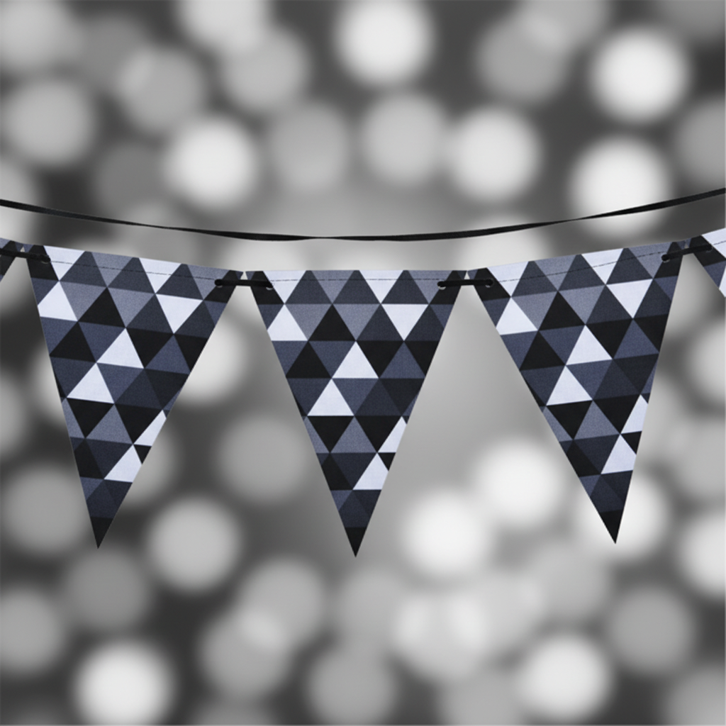 Close up detail of black white chequered fractal design bunting triangular flags hung with string
