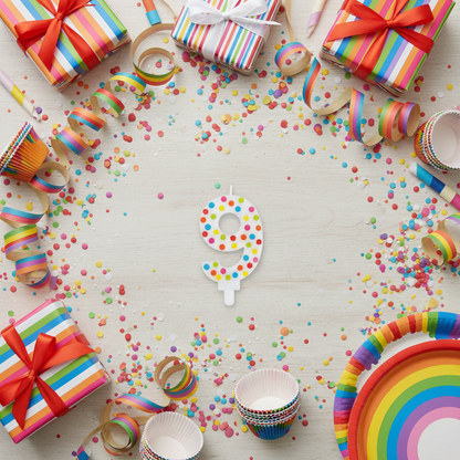 Multicolor polka dot number 9 candle flat lay with streamers gift boxes and rainbow party decor